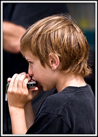 Young musician on the harmonica